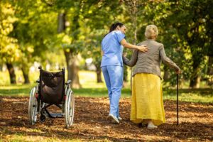 Older adults paint and arrange flowers together at a bright assisted living activity table.